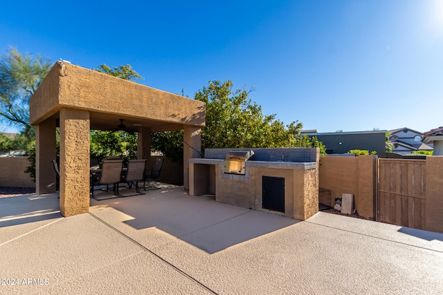 view of patio featuring area for grilling, ceiling fan, and a grill