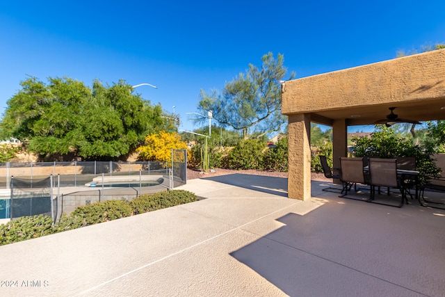 view of patio featuring ceiling fan and a fenced in pool