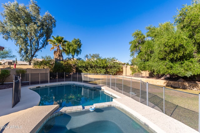 view of pool with an in ground hot tub