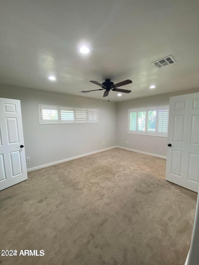 carpeted empty room with ceiling fan