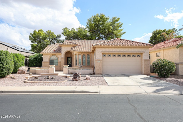 mediterranean / spanish home featuring a garage