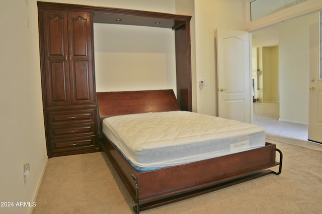 bedroom featuring light colored carpet