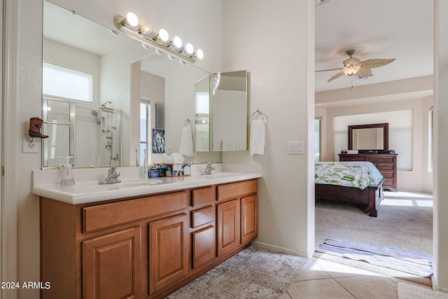 bathroom with tile patterned flooring, vanity, ceiling fan, and a shower with shower door