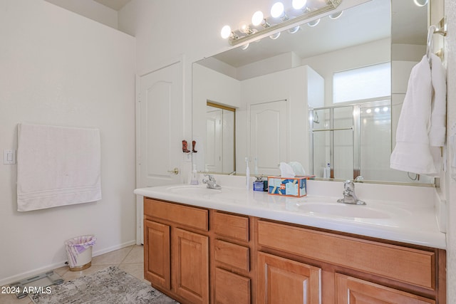 bathroom featuring tile patterned flooring, vanity, and an enclosed shower