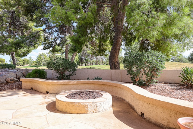 view of patio / terrace featuring an outdoor fire pit