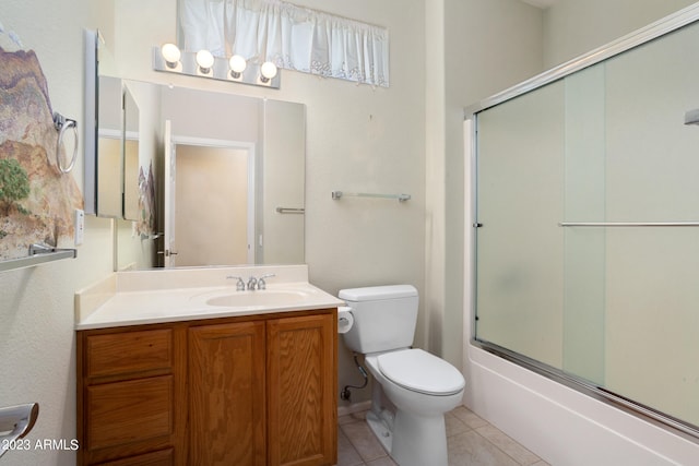 full bathroom with vanity, shower / bath combination with glass door, toilet, and tile patterned flooring