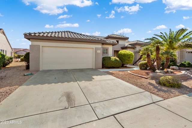 mediterranean / spanish-style home with a garage