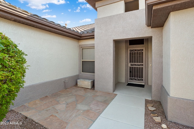 property entrance with a patio