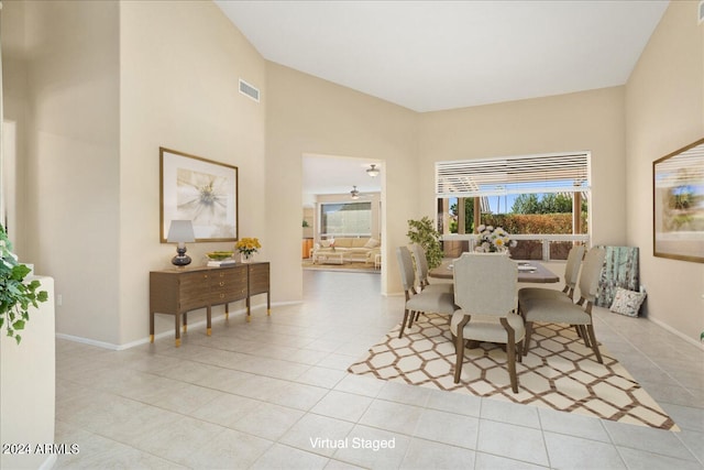 dining room featuring lofted ceiling and light tile patterned floors