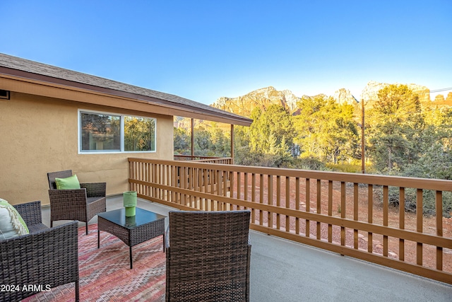 wooden deck featuring a mountain view and an outdoor living space