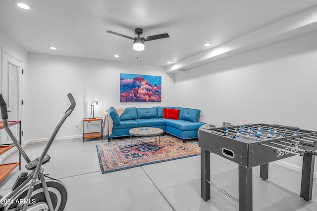 playroom featuring concrete flooring and ceiling fan