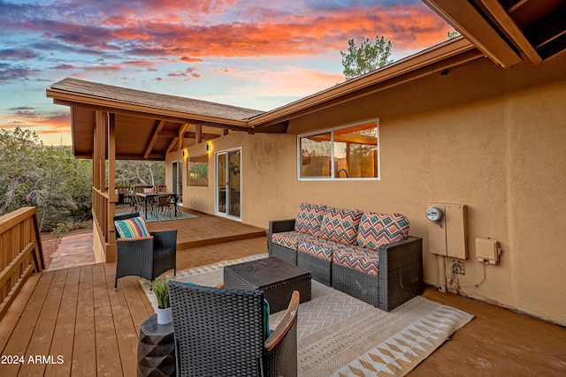 deck at dusk featuring an outdoor hangout area