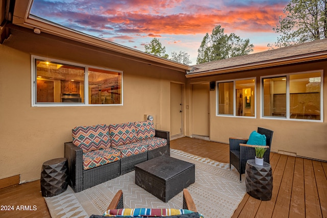 deck at dusk with outdoor lounge area