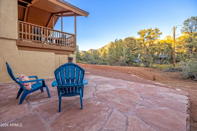 view of patio / terrace with a mountain view and a balcony