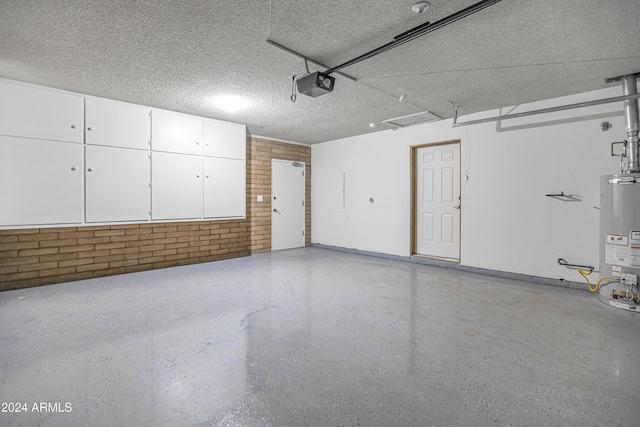 garage with a garage door opener and water heater