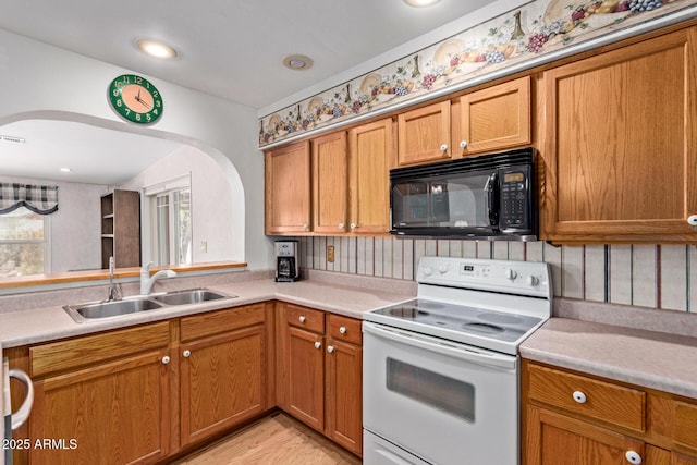 922 S 80th St, Mesa, AZ 85208 - kitchen with black microwave, electric stove, a sink, arched walkways, and light countertops