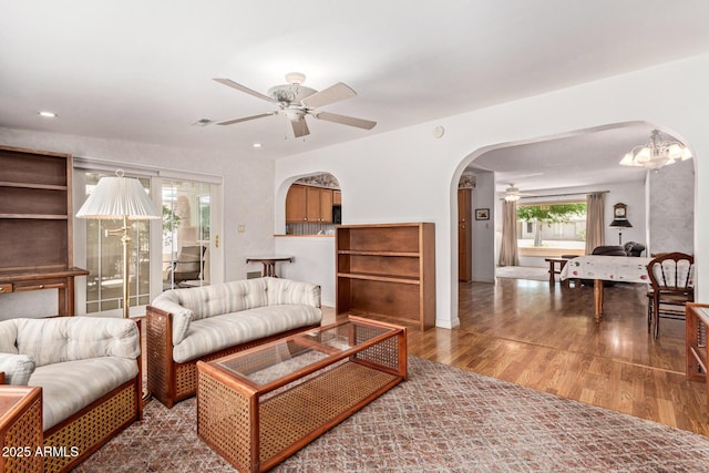 922 S 80th St, Mesa, AZ 85208 - living area featuring arched walkways, ceiling fan, wood finished floors, recessed lighting, and a chandelier