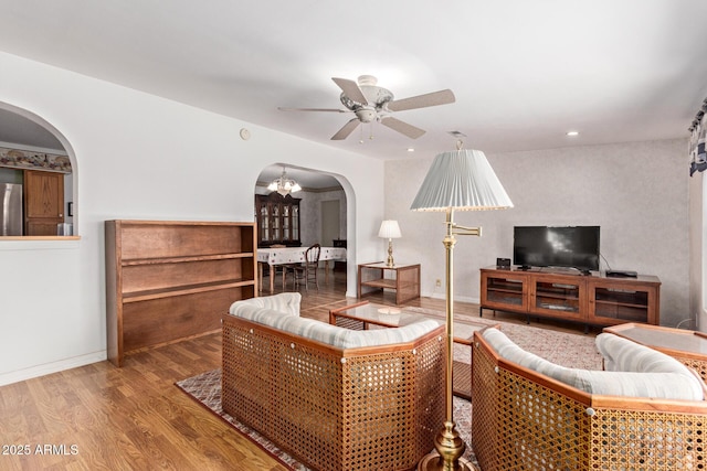 922 S 80th St, Mesa, AZ 85208 - living area with arched walkways, ceiling fan, wood finished floors, a chandelier, and recessed lighting