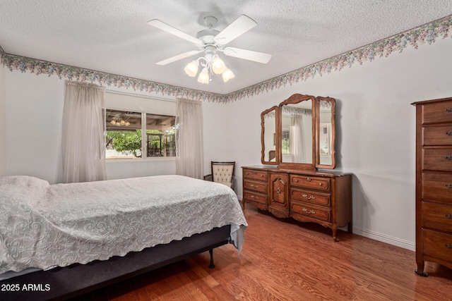 922 S 80th St, Mesa, AZ 85208 - bedroom featuring a textured ceiling, wood finished floors, and a ceiling fan