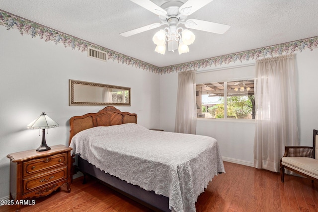 922 S 80th St, Mesa, AZ 85208 - bedroom with light wood-type flooring, baseboards, a textured ceiling, and a ceiling fan