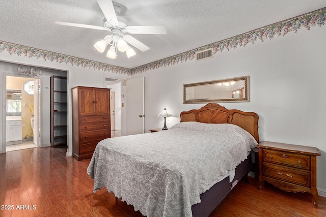 922 S 80th St, Mesa, AZ 85208 - bedroom featuring a textured ceiling, wood finished floors, ceiling fan, ensuite bathroom, and baseboards