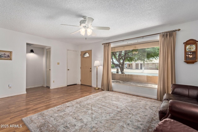 922 S 80th St, Mesa, AZ 85208 - living area with wood finished floors, a ceiling fan, a textured ceiling, and baseboards