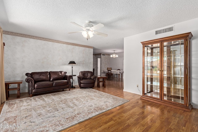922 S 80th St, Mesa, AZ 85208 - living room featuring a ceiling fan, wood finished floors, a textured ceiling, a chandelier, and baseboards