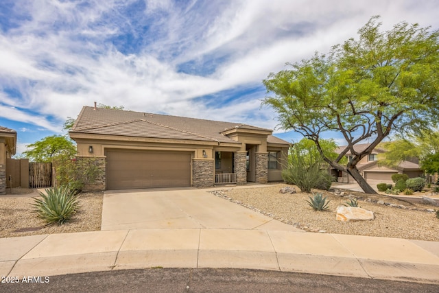 10623 E Acacia Dr, Scottsdale, AZ 85255 - view of front of house featuring stone siding, an attached garage, a tiled roof, stucco siding, and concrete driveway