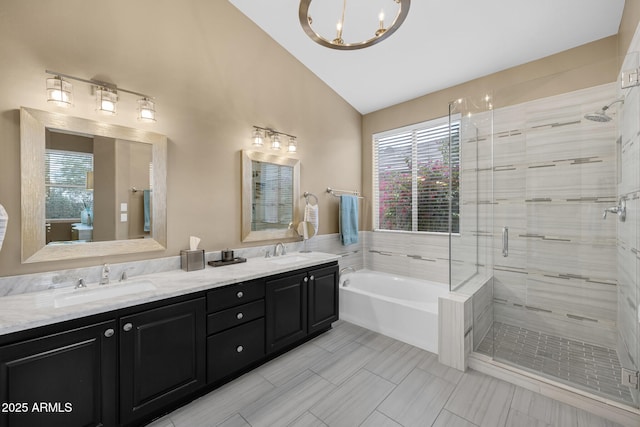 10623 E Acacia Dr, Scottsdale, AZ 85255 - bathroom with a stall shower, a bath, a sink, double vanity, and vaulted ceiling