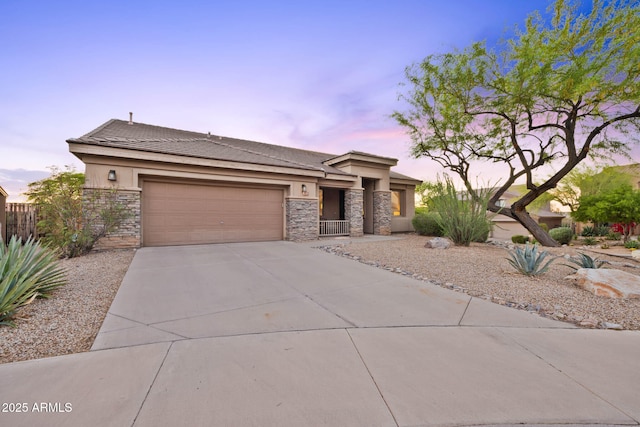 10623 E Acacia Dr, Scottsdale, AZ 85255 - view of front of property featuring fence, an attached garage, stucco siding, concrete driveway, and stone siding