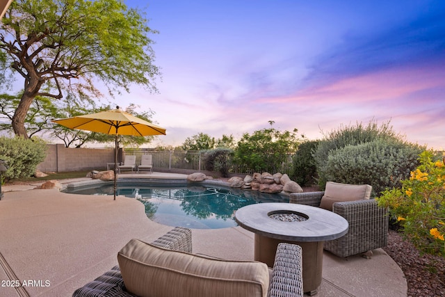 10623 E Acacia Dr, Scottsdale, AZ 85255 - pool at dusk with a fire pit, a patio, a fenced backyard, and a fenced in pool