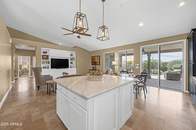 10623 E Acacia Dr, Scottsdale, AZ 85255 - kitchen featuring lofted ceiling, pendant lighting, stone tile floors, light stone countertops, and a kitchen island