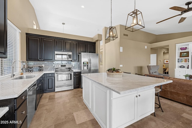 10623 E Acacia Dr, Scottsdale, AZ 85255 - kitchen with a center island, a sink, stainless steel appliances, open floor plan, and ceiling fan