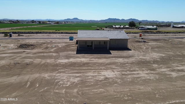 drone / aerial view with a mountain view and a rural view