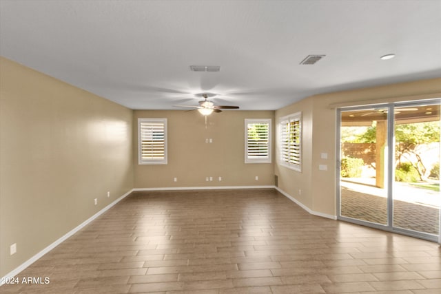 empty room featuring ceiling fan and hardwood / wood-style floors