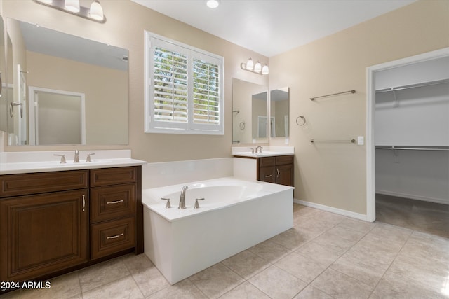 bathroom with vanity, a bathtub, and tile patterned floors