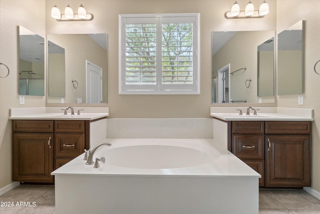 bathroom featuring vanity, a tub, and tile patterned flooring