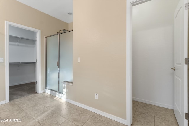 bathroom featuring walk in shower and tile patterned floors