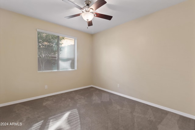 carpeted empty room featuring ceiling fan