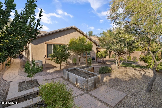 back of house with central AC and a patio area