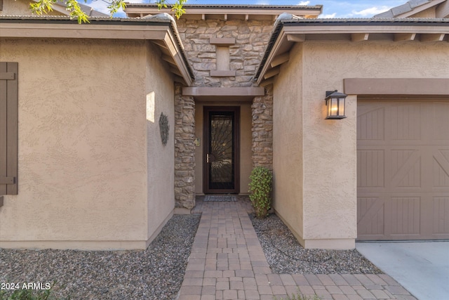 view of exterior entry with a garage