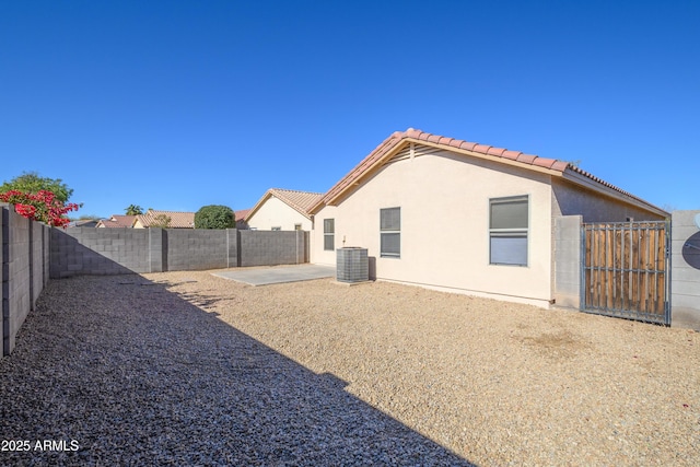 rear view of property with a patio and central air condition unit