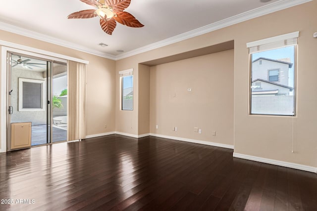 unfurnished room with ornamental molding, plenty of natural light, dark wood finished floors, and a ceiling fan