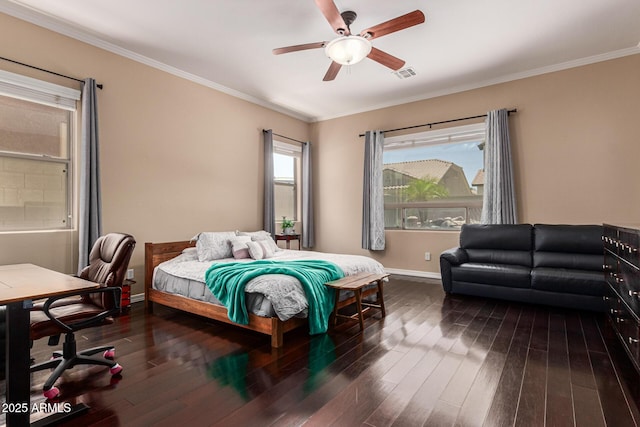 bedroom featuring dark wood-style floors, crown molding, visible vents, ceiling fan, and baseboards