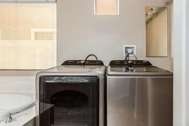 laundry room with laundry area and washing machine and clothes dryer