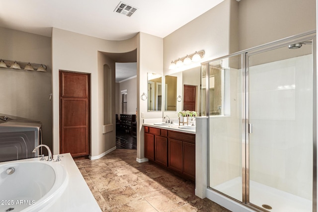 full bathroom featuring double vanity, a stall shower, visible vents, a sink, and a bath