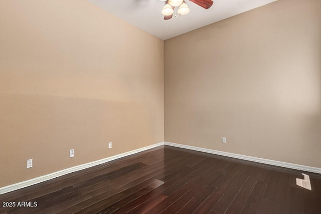 empty room with dark wood-style flooring, ceiling fan, and baseboards