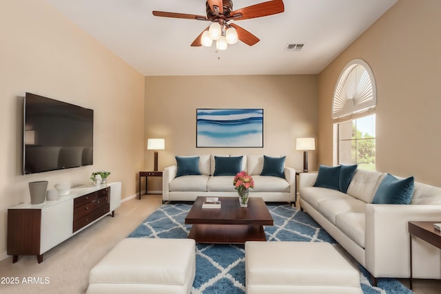 living room featuring light carpet, baseboards, visible vents, and a ceiling fan