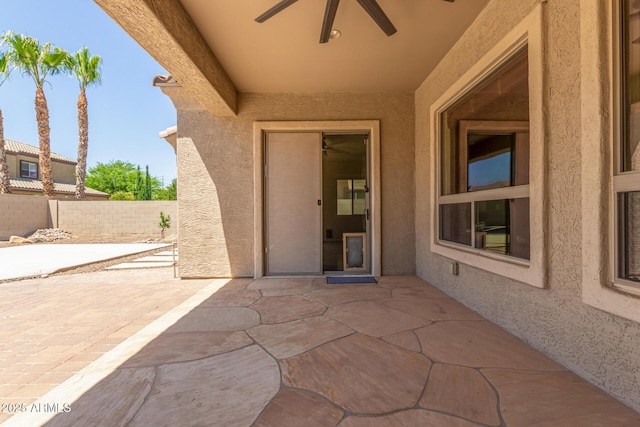 view of patio / terrace featuring ceiling fan and fence