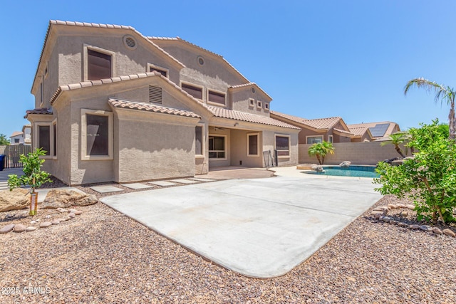 rear view of property with a patio area, a fenced backyard, a fenced in pool, and stucco siding